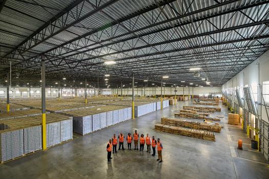Large warehouse with EFL employee gathered