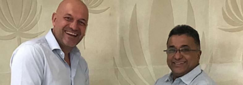 EFL staff shakes hands with Caliber staff