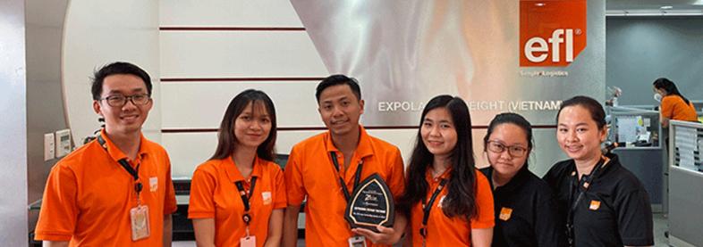 EFL staff holding award