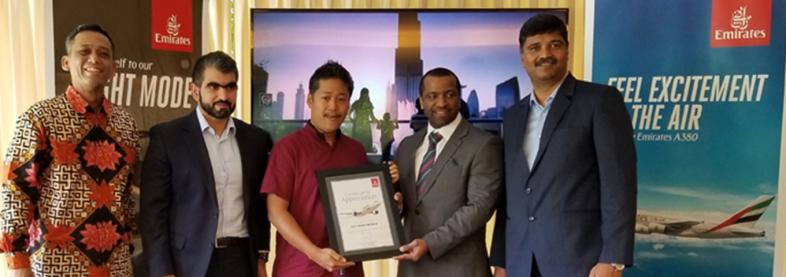 EFL staff holding award