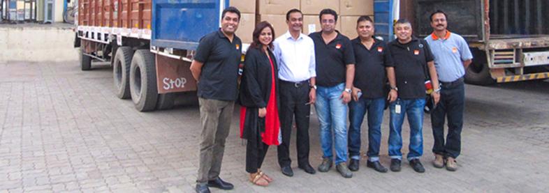 EFL staff smiling with trucks