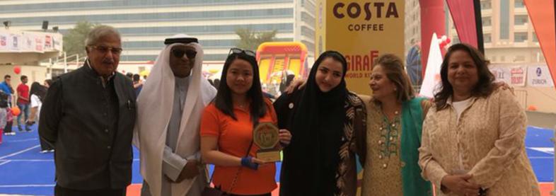 EFL staff holding award